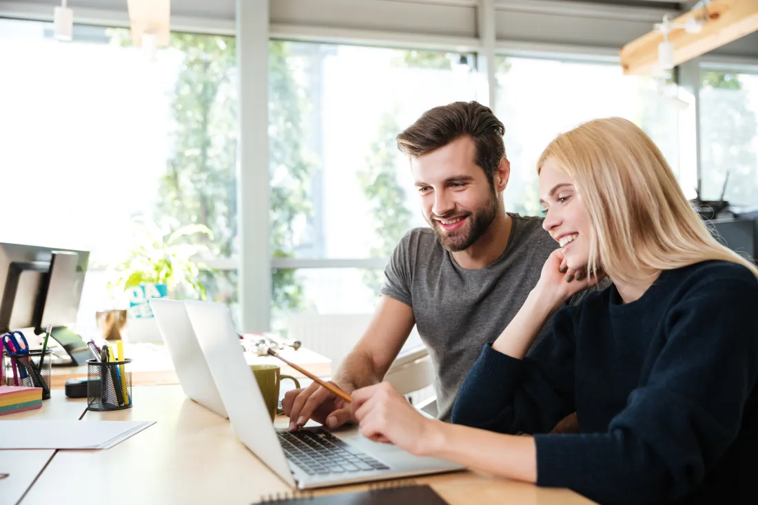 Reviewing a website project together on a laptop